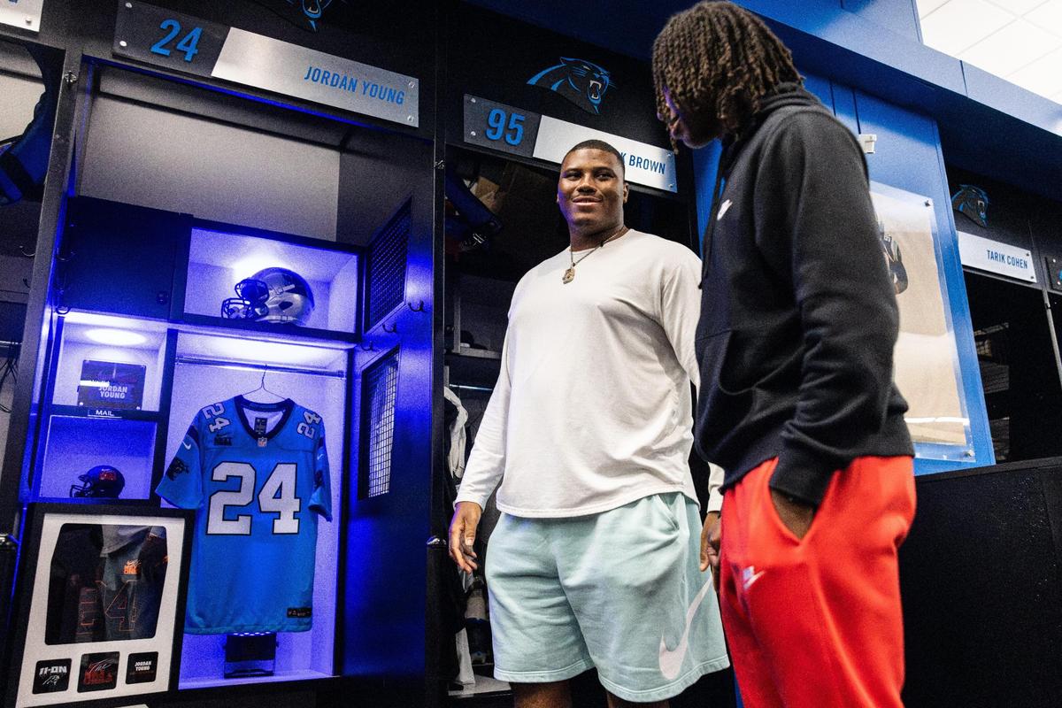 Carolina Panthers DL Derrick Brown surprises Monroe High football star Jordan Young with an invitation to Nike’s “The Next Ones” camp in the locker room at the Bank Of America Stadium in Charlotte, N.C., on Friday, January 26, 2024.