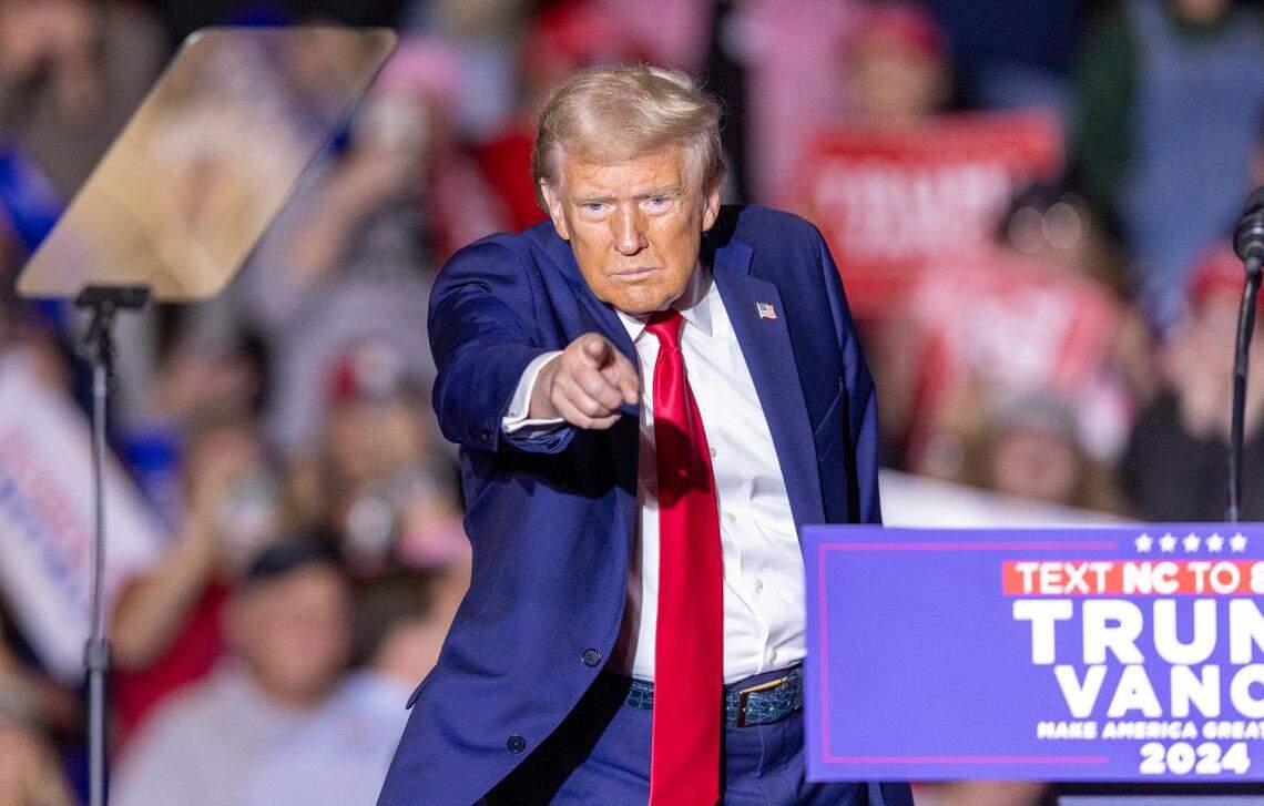 Former President Donald Trump acknowledges the crowd while leaving the stage following a rally speech at Minges Coliseum in Greenville on Monday, Oct. 21, 2024.