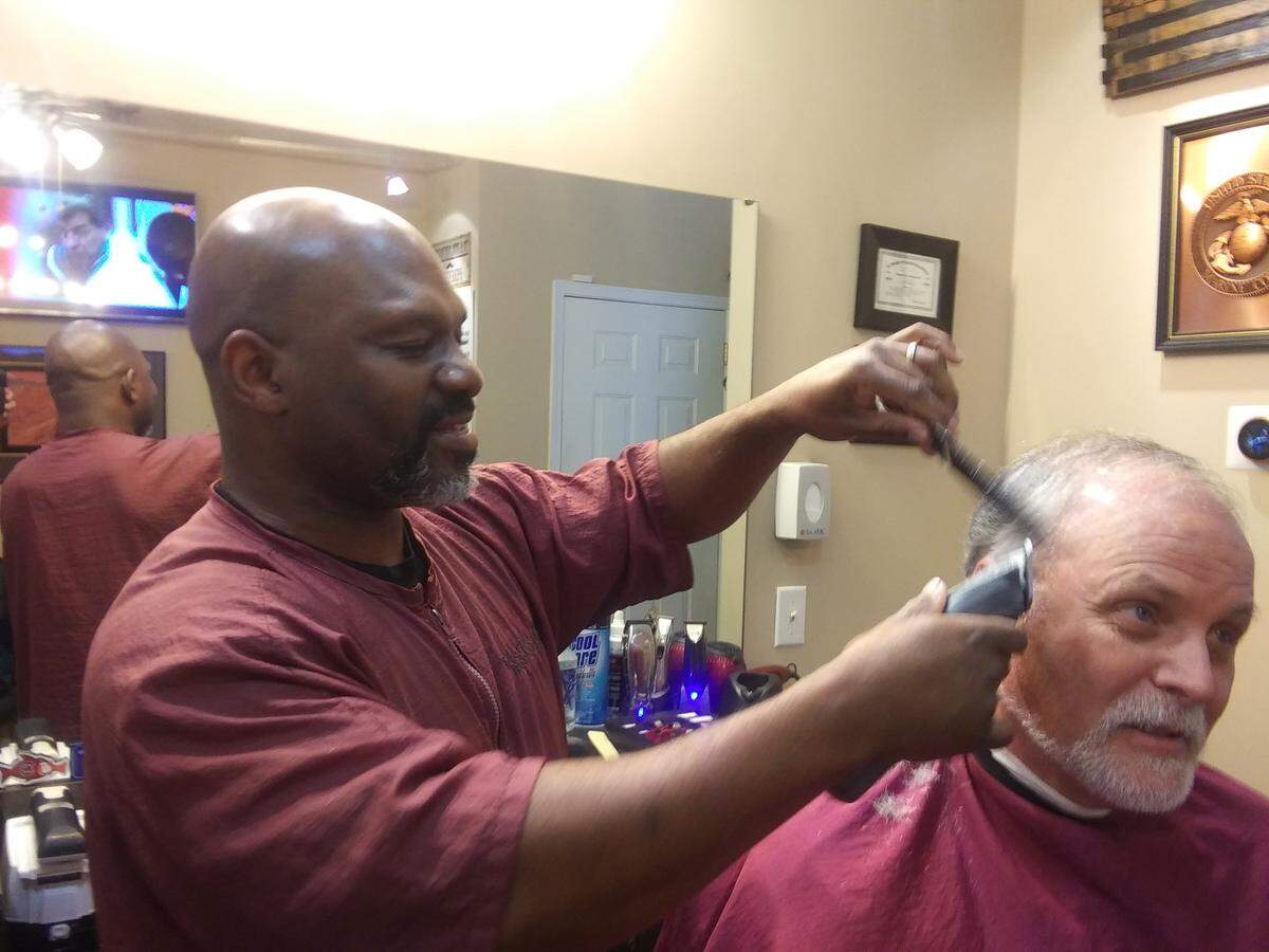 Eric DuRant, owner of Market Place Barbershop in Mooresville, cuts customer Larry Horton’s hair on Tuesday. DuRant offered tips to the Observer on how to cut your own hair if the government order closing salons and barbershops on Wednesday goes on too long and you’re tempted to pull out the scissors.