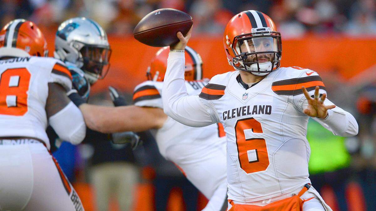 Cleveland Browns quarterback Baker Mayfield, right, drops back to pass to a receiver during third quarter action against the Carolina Panthers at FirstEnergy Stadium in Cleveland, Ohio. The Panthers lost to the Cleveland Browns 26-20 on Sunday, December 9, 2018.