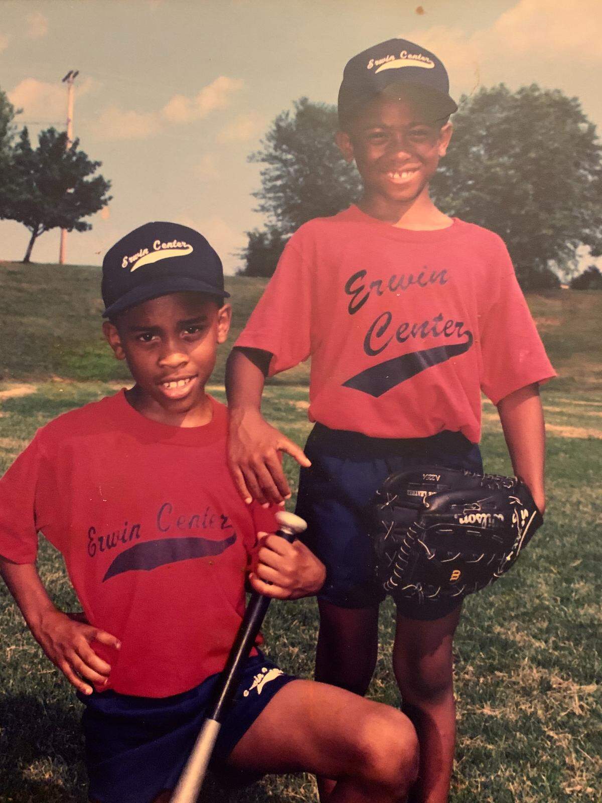 A photo of John and Tavish Moore, when they were young, at a T-ball field.