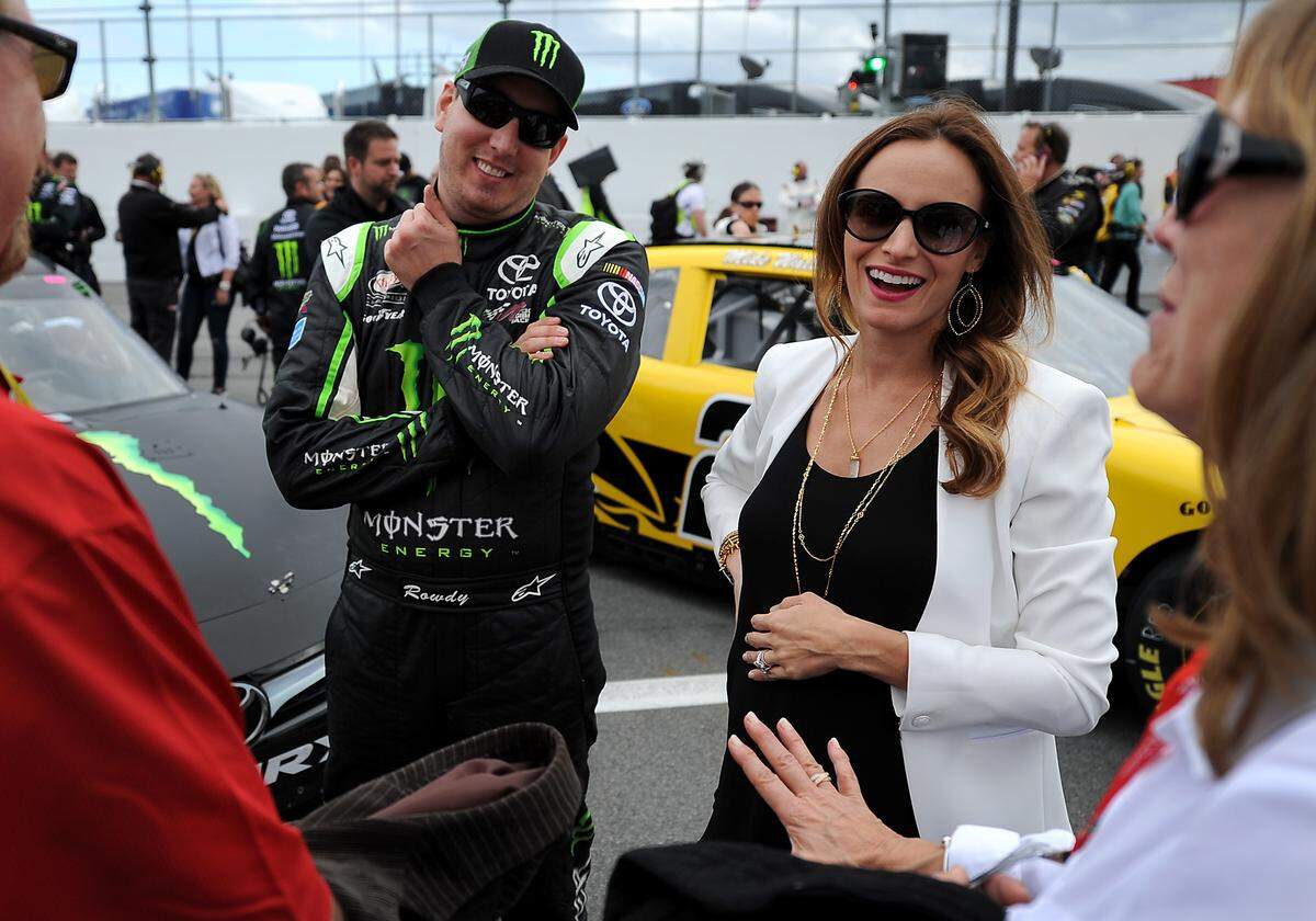 (Center Left-Right) NASCAR Xfinity Series driver Kyle Busch and his wife, Samantha talk with acquaintances  prior to the 34th Annual Alert Today Florida 300 at Daytona International Speedway on Saturday, February 21, 2015. Kyle Busch would be injured in a wreck during the race. 