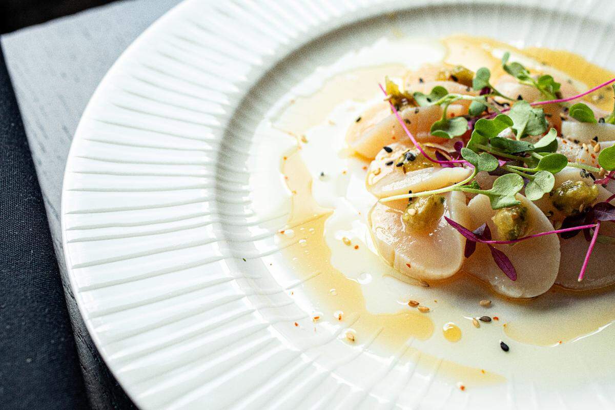 The Hokkaido Scallop Crudo at Mizu is plated with celery verde oil.