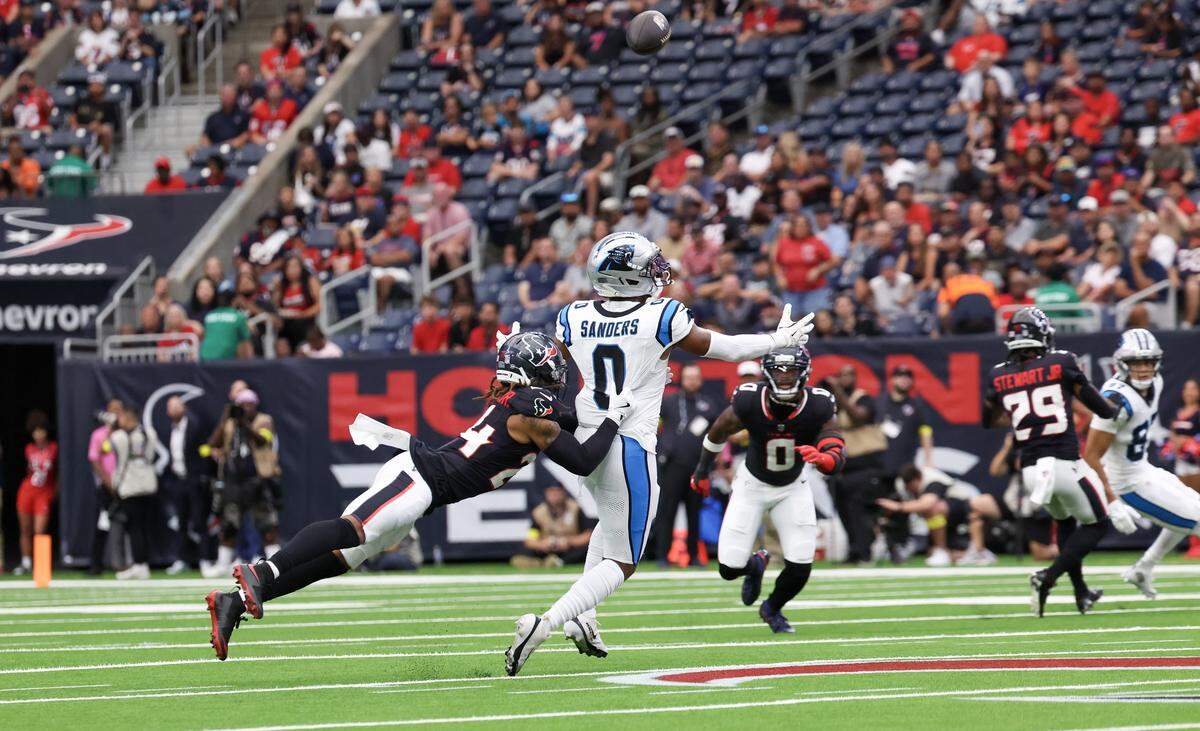 Aug 16, 2025; Houston, Texas, USA; Houston Texans cornerback Derek Stingley Jr. (24) breaks up the pass intended for Carolina Panthers tight end Ja'Tavion Sanders (0) in the first quarter at NRG Stadium. 