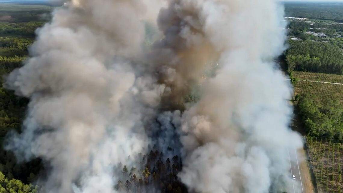Wildfires in Georgia and Florida have forced evacuations, road closures and burn bans as the drought-fueled fires burn thousands of acres.