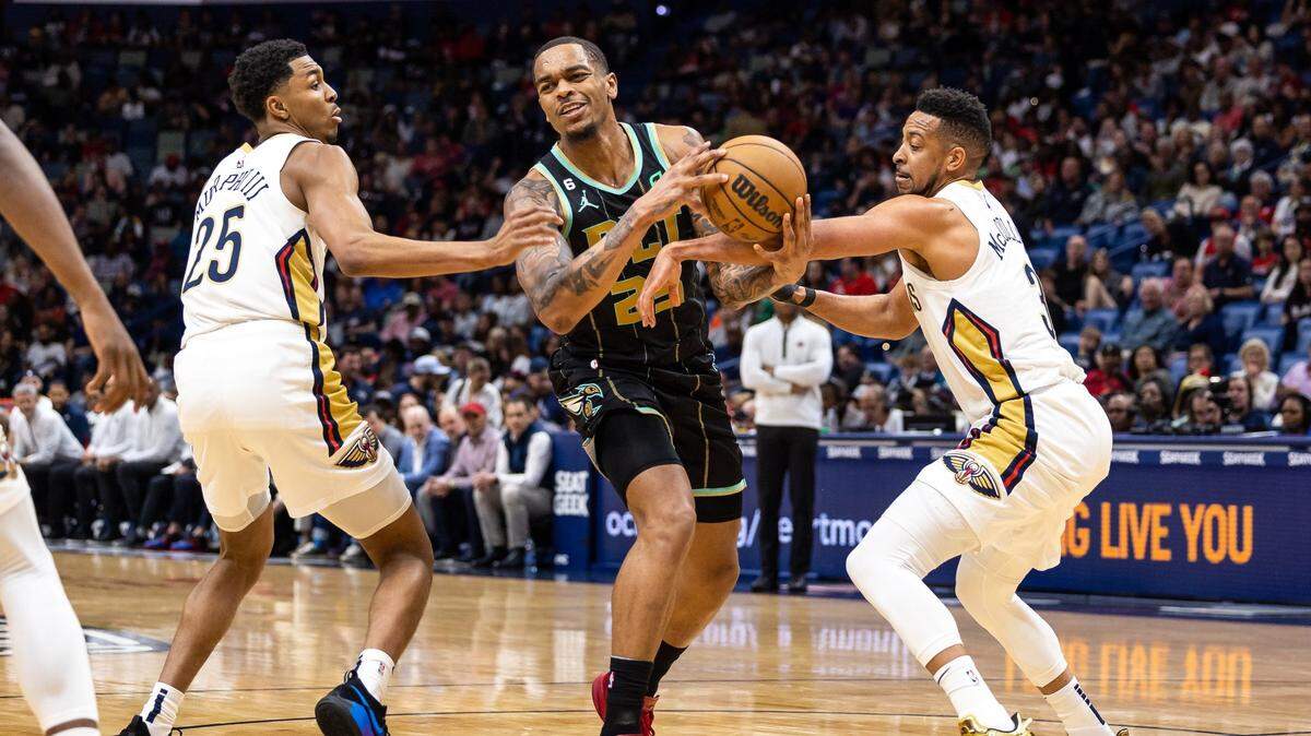 Mar 23, 2023; New Orleans, Louisiana, USA; Charlotte Hornets forward P.J. Washington (25) is fouled by New Orleans Pelicans guard Trey Murphy III (25) and guard CJ McCollum (3) during the first half at Smoothie King Center. Mandatory Credit: Stephen Lew-USA TODAY Sports