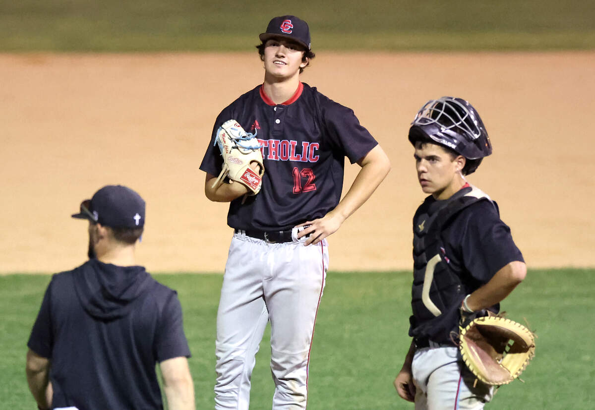 Charlotte Catholic’s pitcher Mason Child, center, waits on the mound for a discussion with his coach during action against Providence High on Thursday, May 2, 2024 in the Southwestern 4A Championship game at Granger High School. Catholic defeated Providence 6-4.