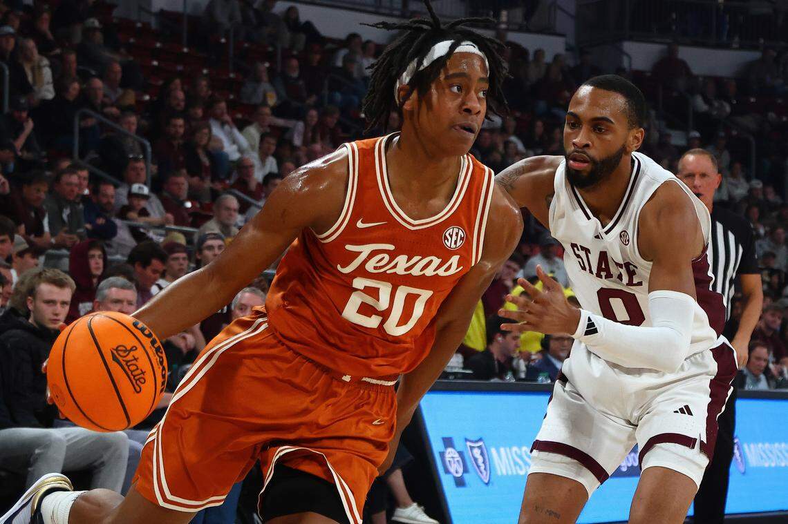 Mar 4, 2025; Starkville, Mississippi, USA; Texas Longhorns guard Tre Johnson (20) drives to the basket as Mississippi State Bulldogs guard Claudell Harris Jr. (0) defends during the first half at Humphrey Coliseum. Mandatory Credit: Petre Thomas-Imagn Images
