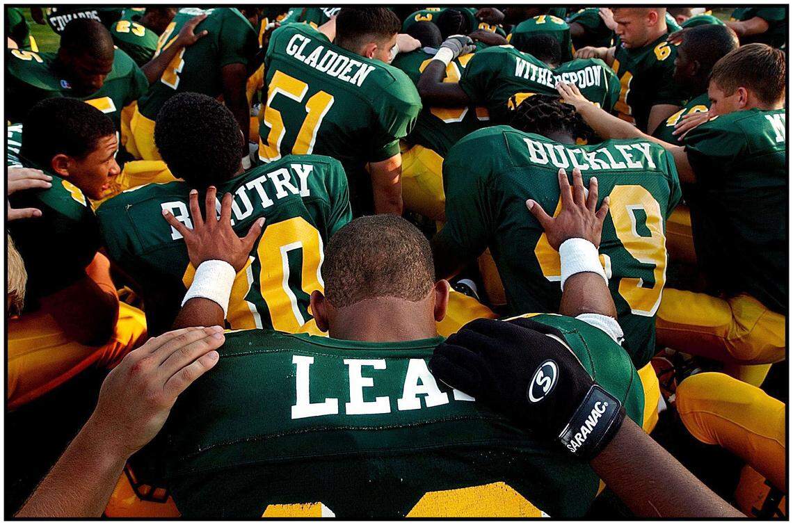Independence Quarterback Chris Leak comes together with teammates to pray prior to the start of the gamme against Myers Park.PATRICK SCHNEIDER/STAFF