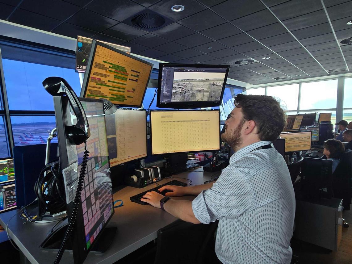 Chase Payton, a customer service manager for American Airlines, reviews passenger information inside the Hub Control Center at Charlotte Douglas International Airport. The tech is used to help passengers not miss connecting flights.