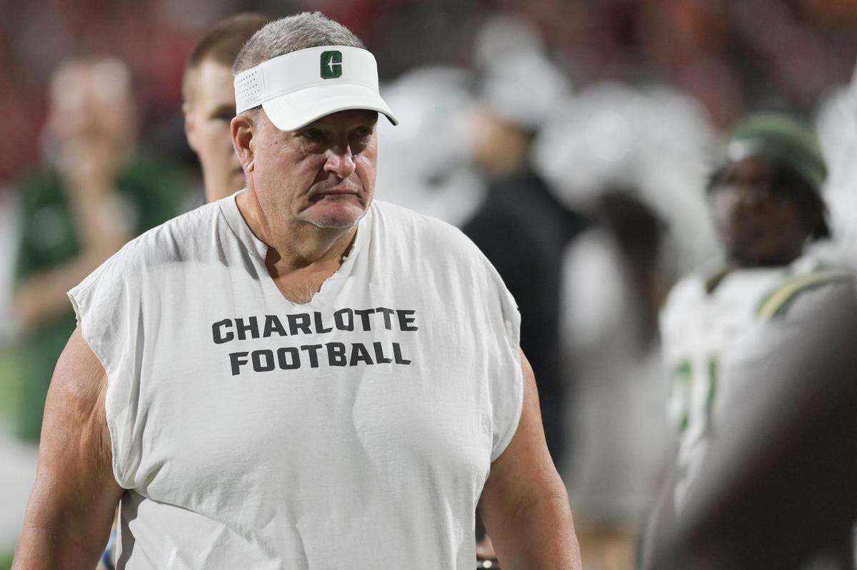 Sep 9, 2023; College Park, Maryland, USA; Charlotte 49ers head coach Biff Poggi walks the sidelines during the first half against the Maryland Terrapins at SECU Stadium.