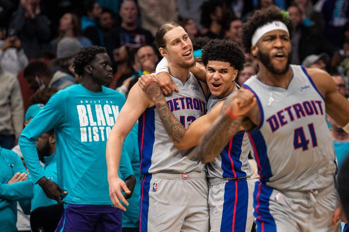 The Pistons Kelly Olynyk, second from left, is embraced by teammate Killlian Hayes after Olynyk hit the game-winning point at the buzzer during the game at Spectrum Center on Sunday, February 27, 2022 in Charlotte, NC. The Pistons defeated the Hornets in overtime, 126-125.