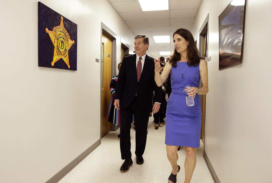 North Carolina Gov. Roy Cooper takes a tour of Cedar Ridge High School with school nurse Jennifer Pepin in Hillsborough, N.C., on Thursday, April 19, 2018, where the Governor announced his budget recommendations for improving school safety and youth mental health.