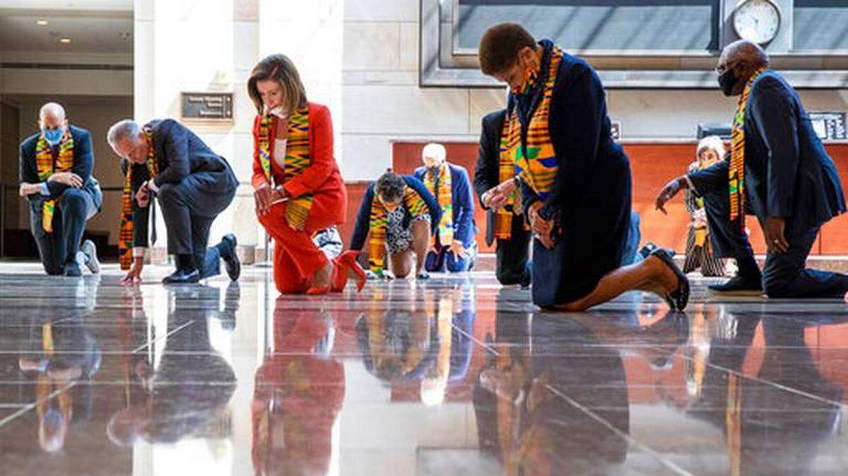 House Speaker Nancy Pelosi, center, and other members of Congress, kneel to observe a moment of silence to honor George Floyd and others killed during police interactions. On June 8 Democrats proposed a sweeping overhaul of police oversight and procedures called the Justice in Policing Act.