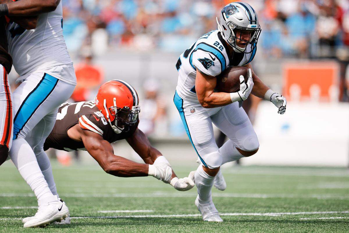 Carolina Panthers running back Christian McCaffrey (22) runs the ball past Cleveland Browns defensive end Myles Garrett (95) during a game at Bank of America Stadium in Charlotte, N.C., Sunday, Sept. 11, 2022.
