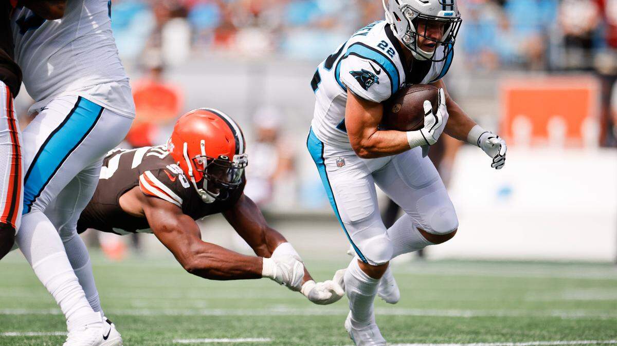 Carolina Panthers running back Christian McCaffrey (22) runs the ball past Cleveland Browns defensive end Myles Garrett (95) during a game at Bank of America Stadium in Charlotte, N.C., Sunday, Sept. 11, 2022.