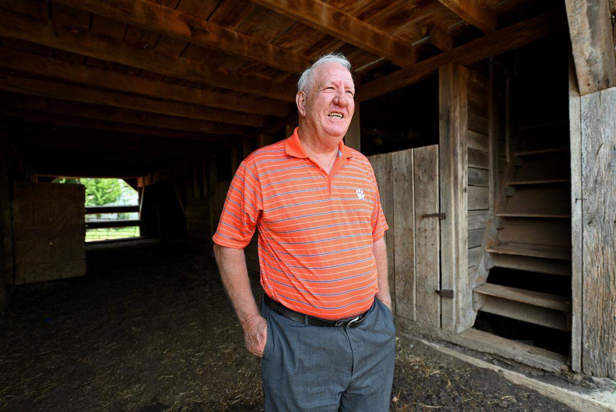 Former Clemson Tigers head football coach Danny Ford stands in the doorway of one of his barns on his farm on Friday, July 22, 2022. Ford led the Tigers to a 12-0 season in 1981. Ford won ACC Coach of the Year in 1981 and was inducted into the College Football Hall of Fame in 2017.