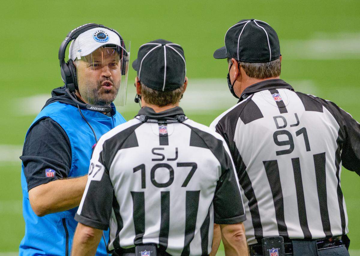 Carolina Panthers head coach Matt Rhule argues a call with line judge Ron Marinucci (107) and head linesman Jerry Bergman (91) at the Mercedes-Benz Superdome on Sunday, October 25, 2020, in New Orleans.
