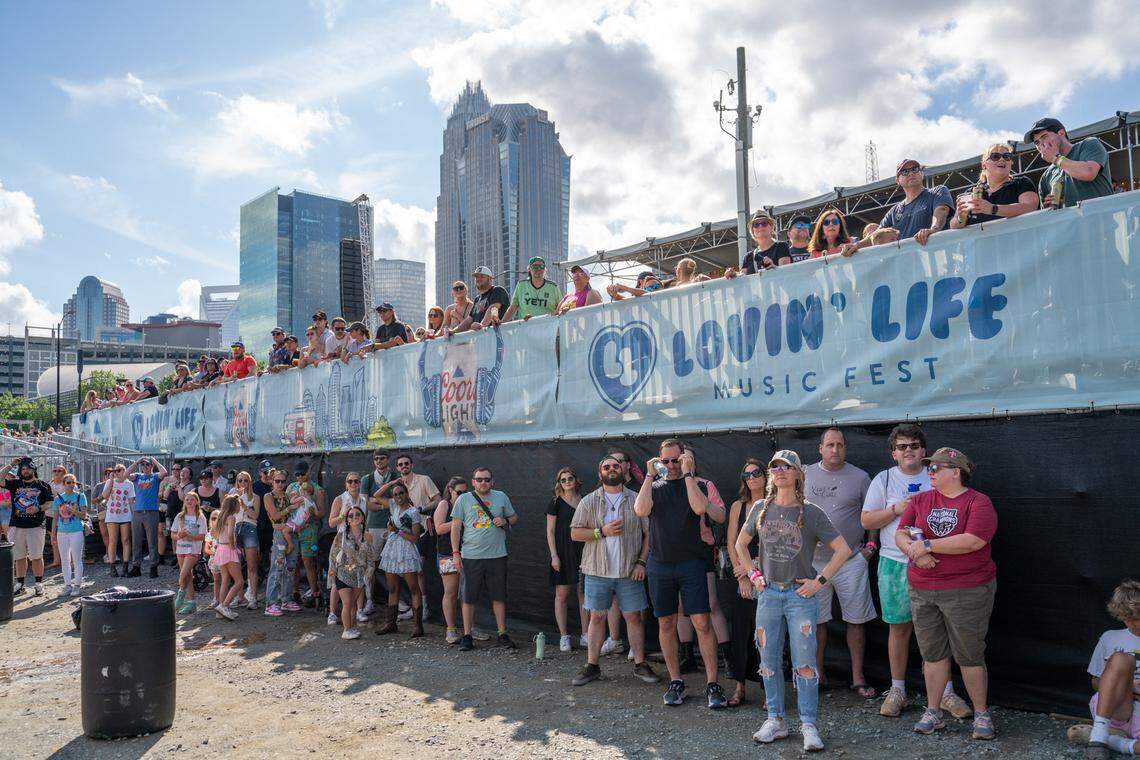 Fans find shade at Lovin’ Life Music Fest during the midday sun.