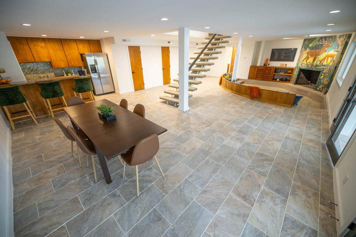 A basement room that includes the floating stairs after renovations.