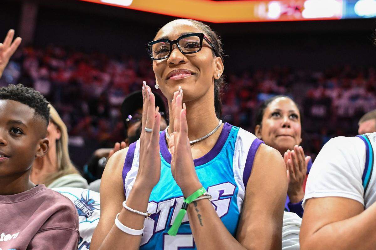 Three-time WNBA MVP A’ja Wilson looks on during the first half of an NBA basketball game between the Miami Heat and Charlotte Hornets on Saturday. Wilson wore a vintage WNBA Charlotte Sting jersey.