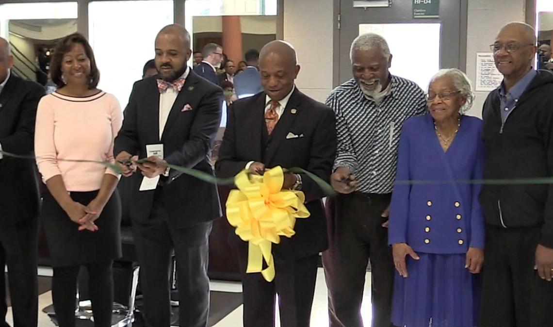 Mecklenburg County Sheriff Garry L. McFadden cuts the ribbon along with other dignitaries during the dedication of the first in-jail barber school in the state, at the Mecklenburg County Jail-North facility, on Monday, April 1, 2019.