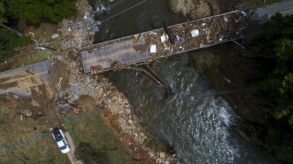 A flood-damaged bridge spans the Pigeon River Thursday, Aug. 19, 2021 after remnants from Tropical Storm Fred caused flooding in parts of Western North Carolina Tuesday. Search and rescue teams continue to search the area as 20 people are missing and 2 people were found dead.