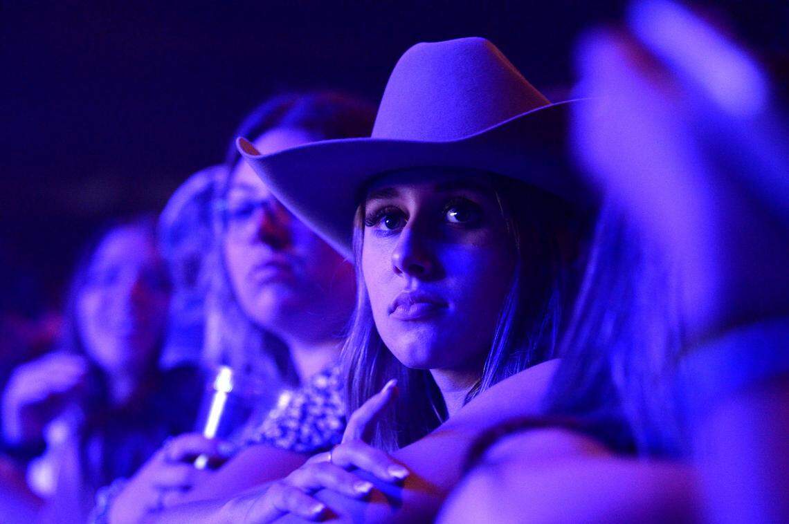 Concertgoers wait for the start of the show on Friday night.