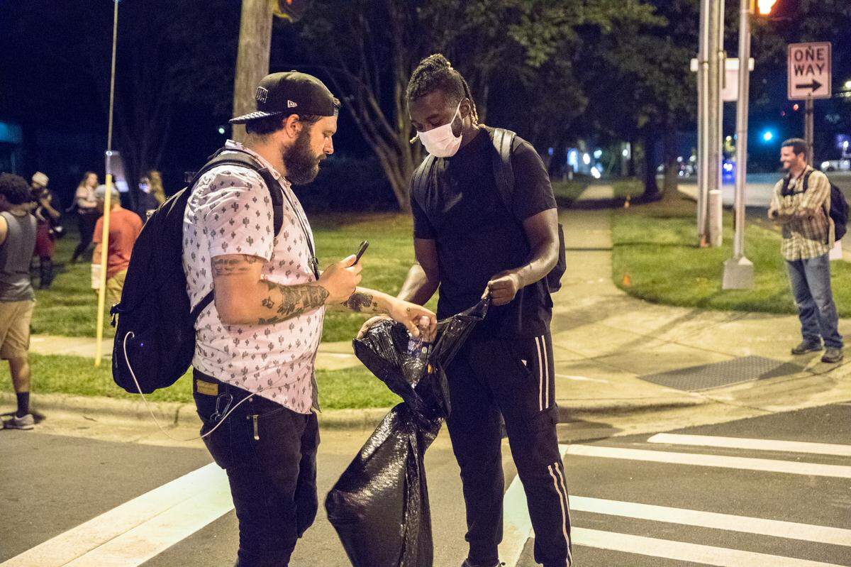 Justin LaFrancois, Publisher of Queen City Nerve, with a clean up volunteer on Day 9 of protests.