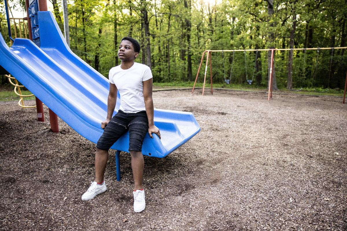 Jonathan Kimble, 14, sits on a slide at Derita Park in Charlotte, N.C., on Friday, April 16, 2021.