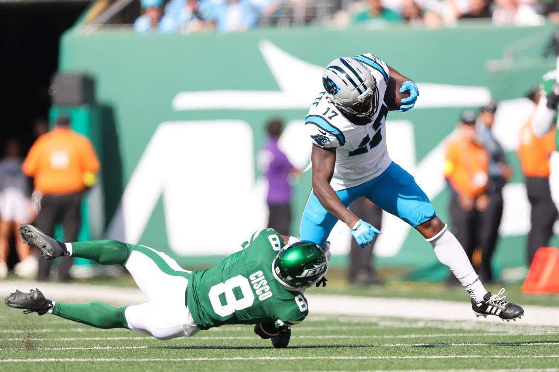 Carolina Panthers wide receiver Xavier Legette (17) is brought down by New York Jets safety Andre Cisco (8) in the second quarter on Sunday in New Jersey.