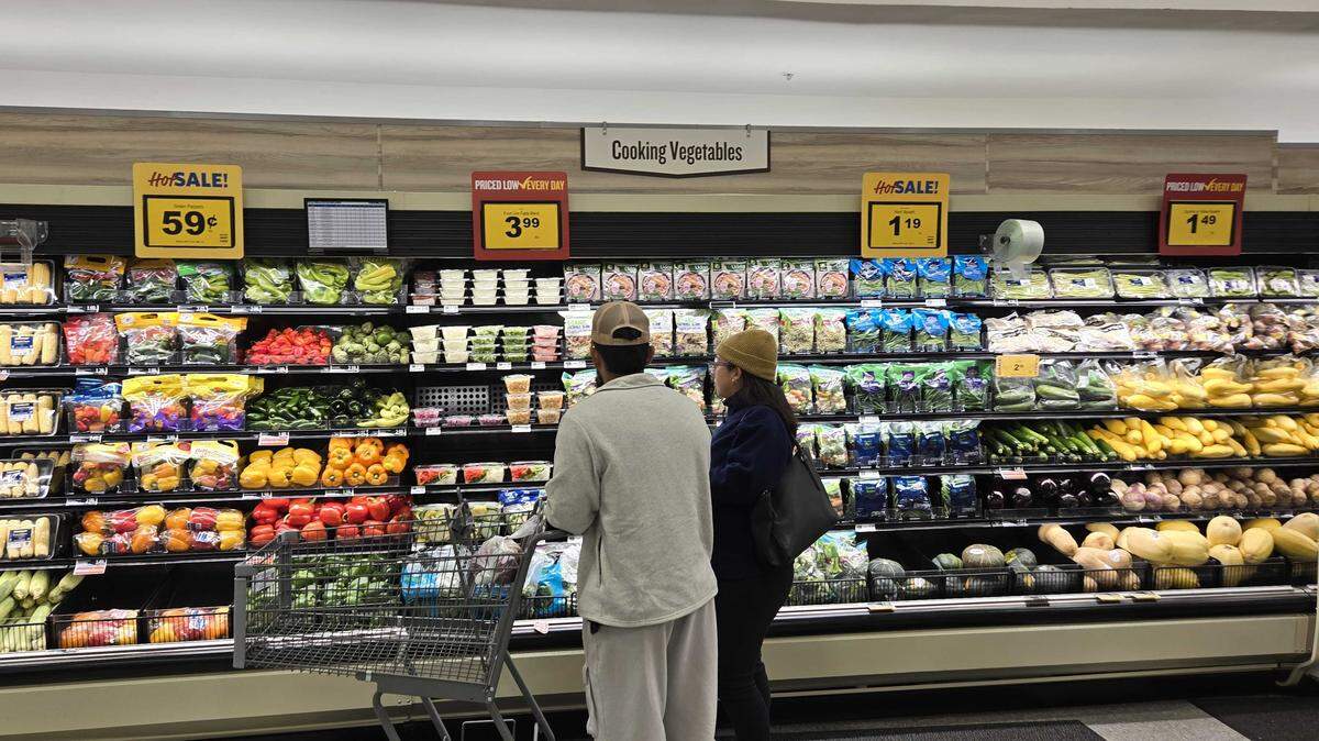 Customers spend time shopping through an upgraded produce section at Food Lion.