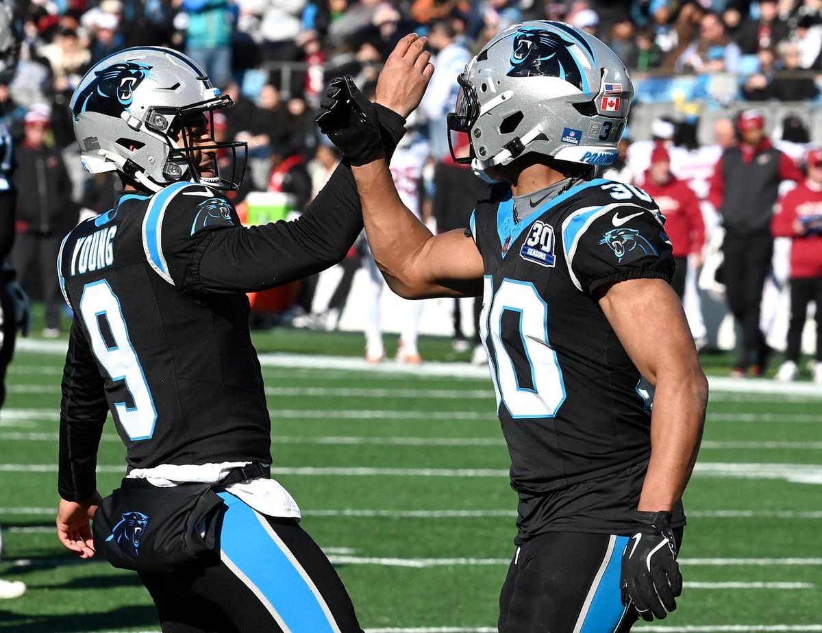 Carolina Panthers quarterback Bryce Young, left, congratulates running back Chuba Hubbard, right, on a touchdown run during action against the Arizona Cardinals at Bank of America Stadium in Charlotte, NC on Sunday, December 22, 2024.