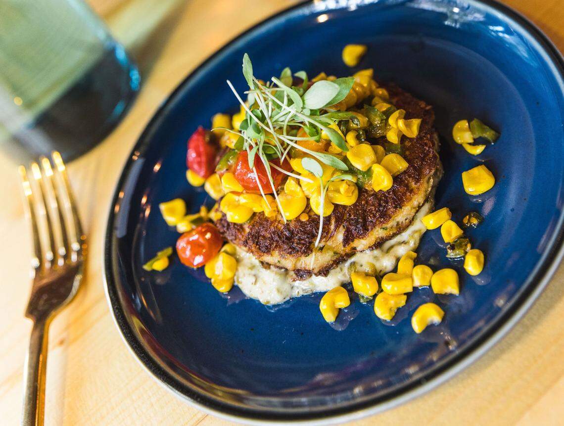 204 North Kitchen & Cocktails’ Crab Cake small plate features fresh lump crab meat crab cake with a caper remoulade, roasted corn and tomatoes.