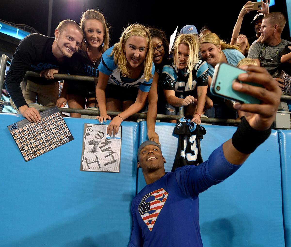 Carolina Panthers quarterback Cam Newton takes a photograph with fans at an Aug. 7, 2015 Fan Fest at Bank of America Stadium.