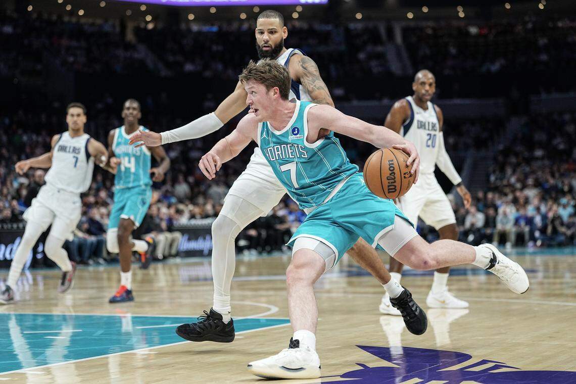 Charlotte Hornets guard Kon Knueppel (7) drives to the basket against Dallas Mavericks forward Caleb Martin (16) during the first half of an NBA basketball game, Tuesday, March 3, 2026, in Charlotte, N.C. 