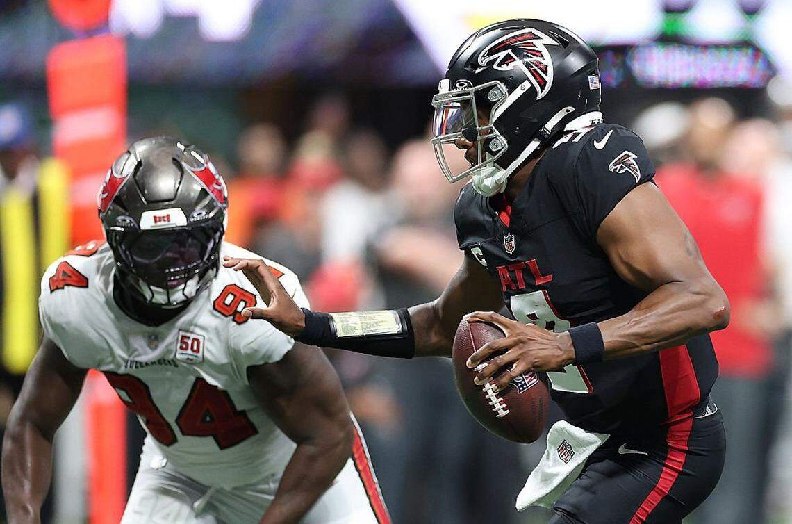 Michael Penix Jr. of the Atlanta Falcons rushes for a touchdown against Calijah Kancey of the Tampa Bay Buccaneers in 2025.
