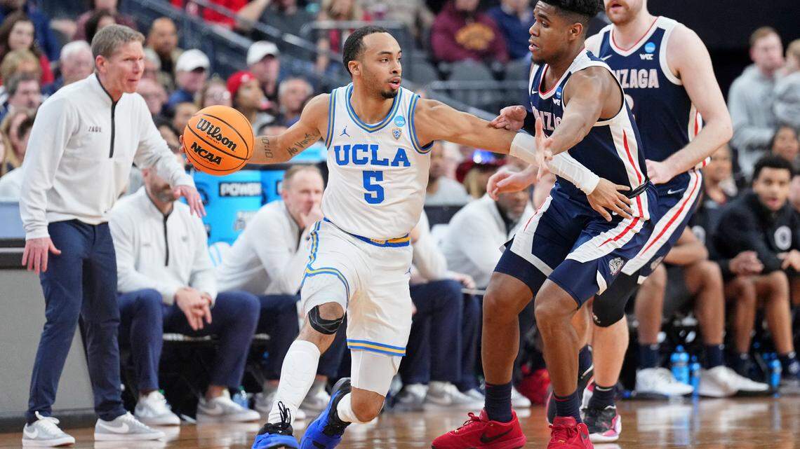UCLA Bruins guard Amari Bailey (5) dribbles the ball against Gonzaga Bulldogs guard Malachi Smith (13) during the first half at T-Mobile Arena.