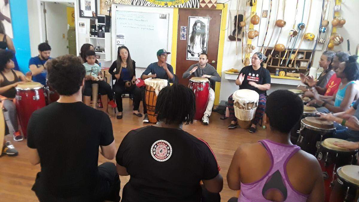 Brazilian percussionist Luciano Xavier, with brown drum, teaches a class in Washington, D.C. He’s one of the featured performers at LAVAGEM!, a celebration of African Brazilian music and dance in Charlotte, April 7-10.