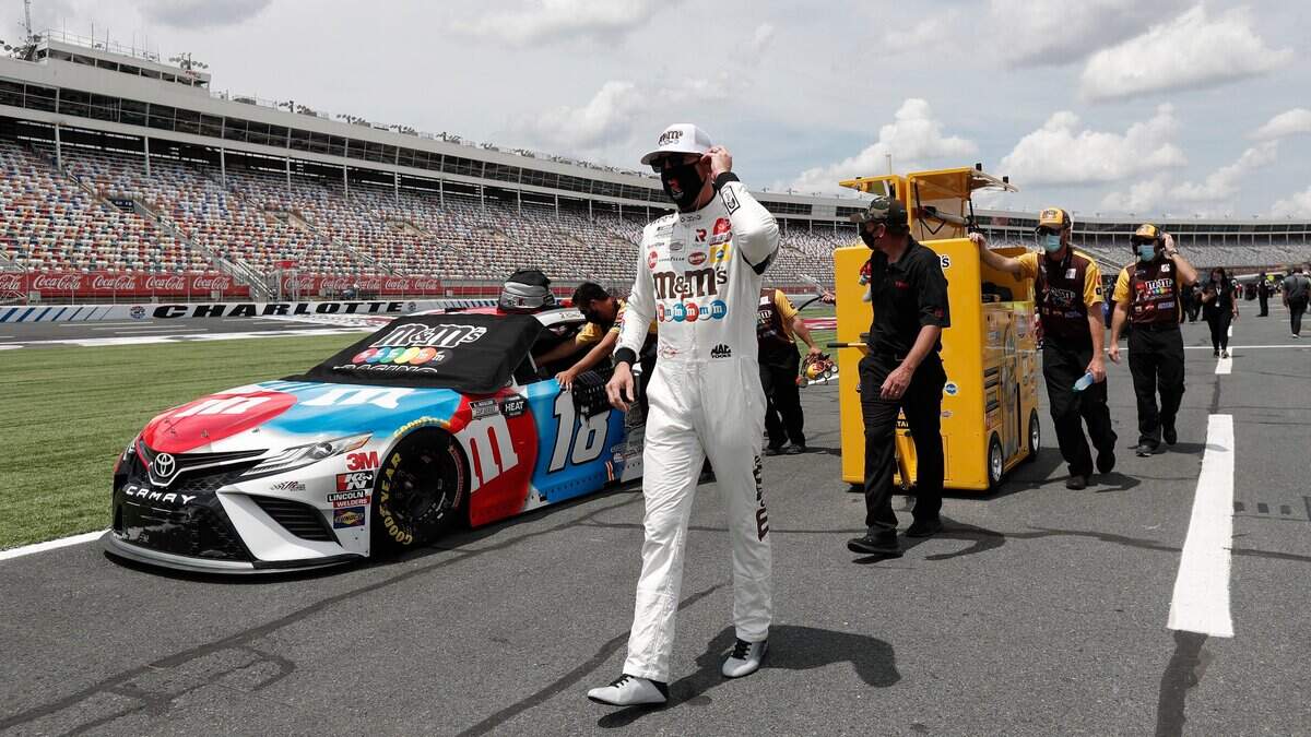 Driver Kyle Busch walks along pit road during qualifying prior to the NASCAR Cup Series auto race at Charlotte Motor Speedway Sunday, May 24, 2020, in Concord, N.C. (AP Photo/Gerry Broome)