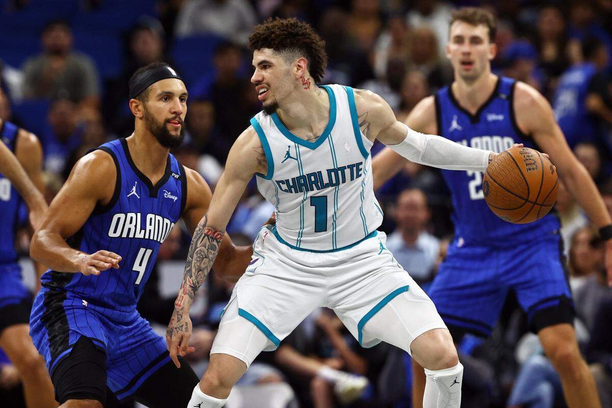Charlotte Hornets guard LaMelo Ball (1) drives to the basket as Orlando Magic guard Jalen Suggs (4) defends during the second half at Kia Center.