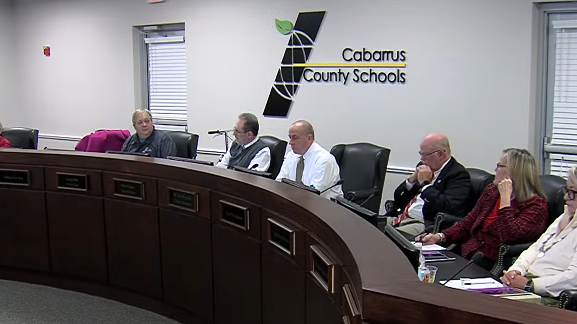 Cabarrus County school board member Greg Mills, pictured second from left, thanks his colleagues on Dec. 1 for saving his life during a heart attack at a closed-session meeting in November.