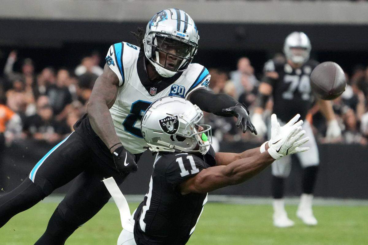 Las Vegas Raiders wide receiver Tre Tucker (11) attempts to catch the ball against Carolina Panthers cornerback Jaycee Horn (8) in the second half at Allegiant Stadium.