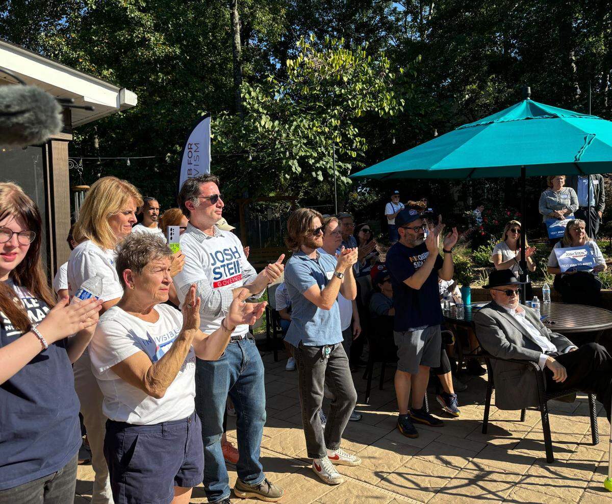 A crowd of Democratic canvassers listen to Attorney General Josh Stein speak in Mecklenburg County on Sunday, Oct. 13, 2024.