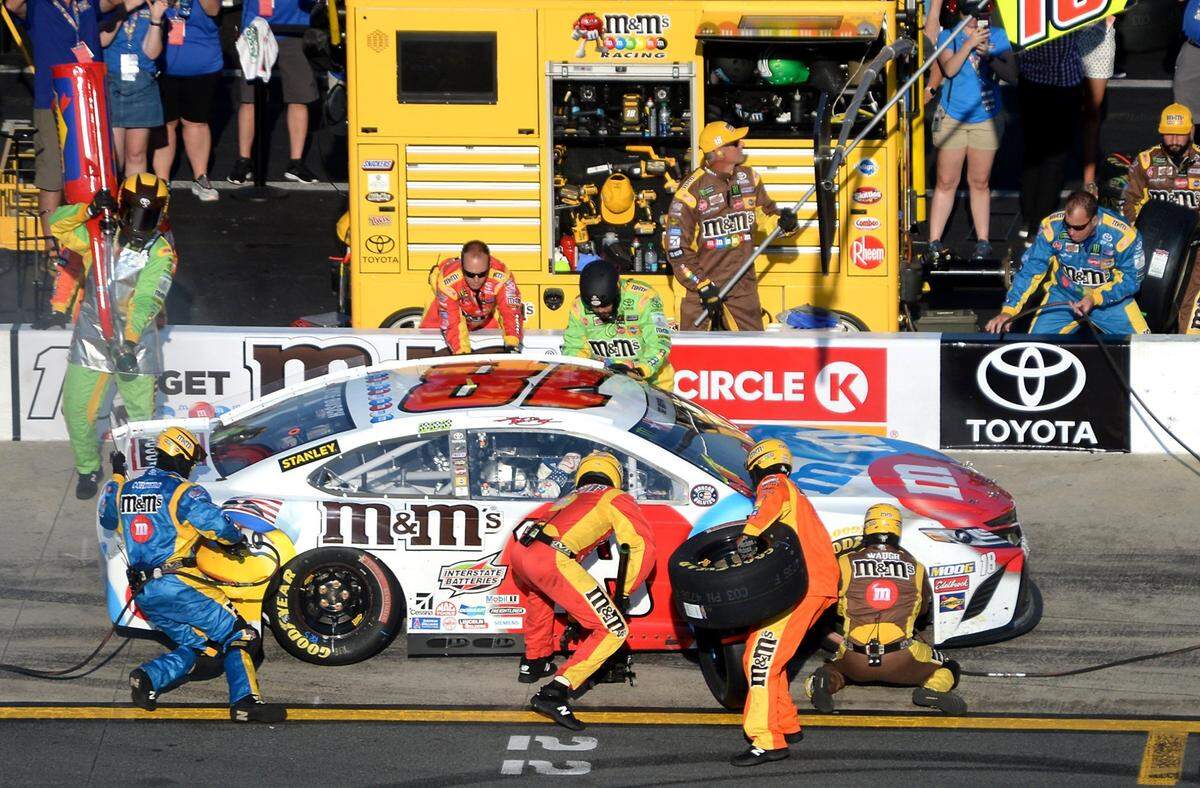 NASCAR driver Kyle Busch’s team hurry to change the tires on the car during a pit stop in the running of the 60th Coca-Cola 600 at Charlotte Motor Speedway in Concord, NC on Sunday, May 26, 2019.