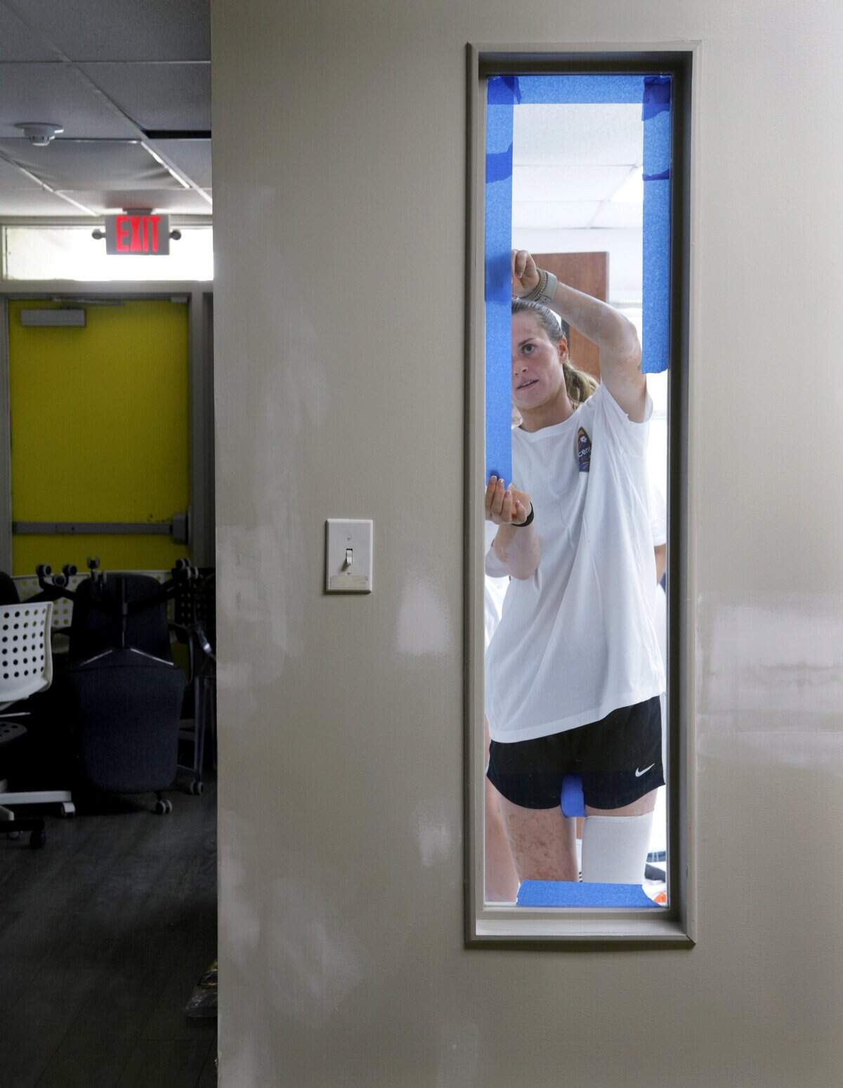 Tennis great Martina Navratilova, a new minority owner of the Carolina Ascent FC, is in town for a promotional event with the team at Dress for Success Charlotte in Charlotte, NC, on Saturday, Sep. 27, 2025. Alyssa Walker, a forward with the Ascent, tapes a window before painting in the new Dress for Success Charlotte location. Jennifer Podis/For the Observer