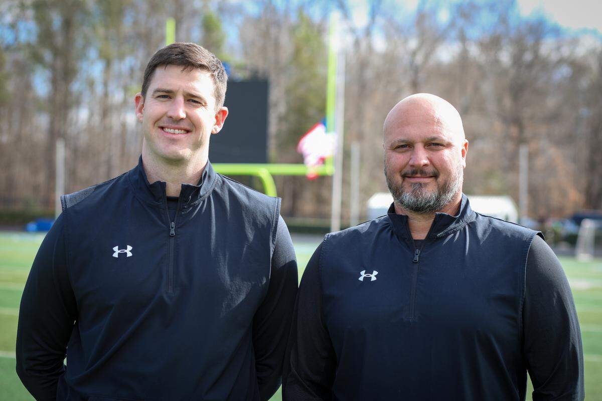 New Charlotte Christian football coach Chris James with former coach Jason Estep (right)