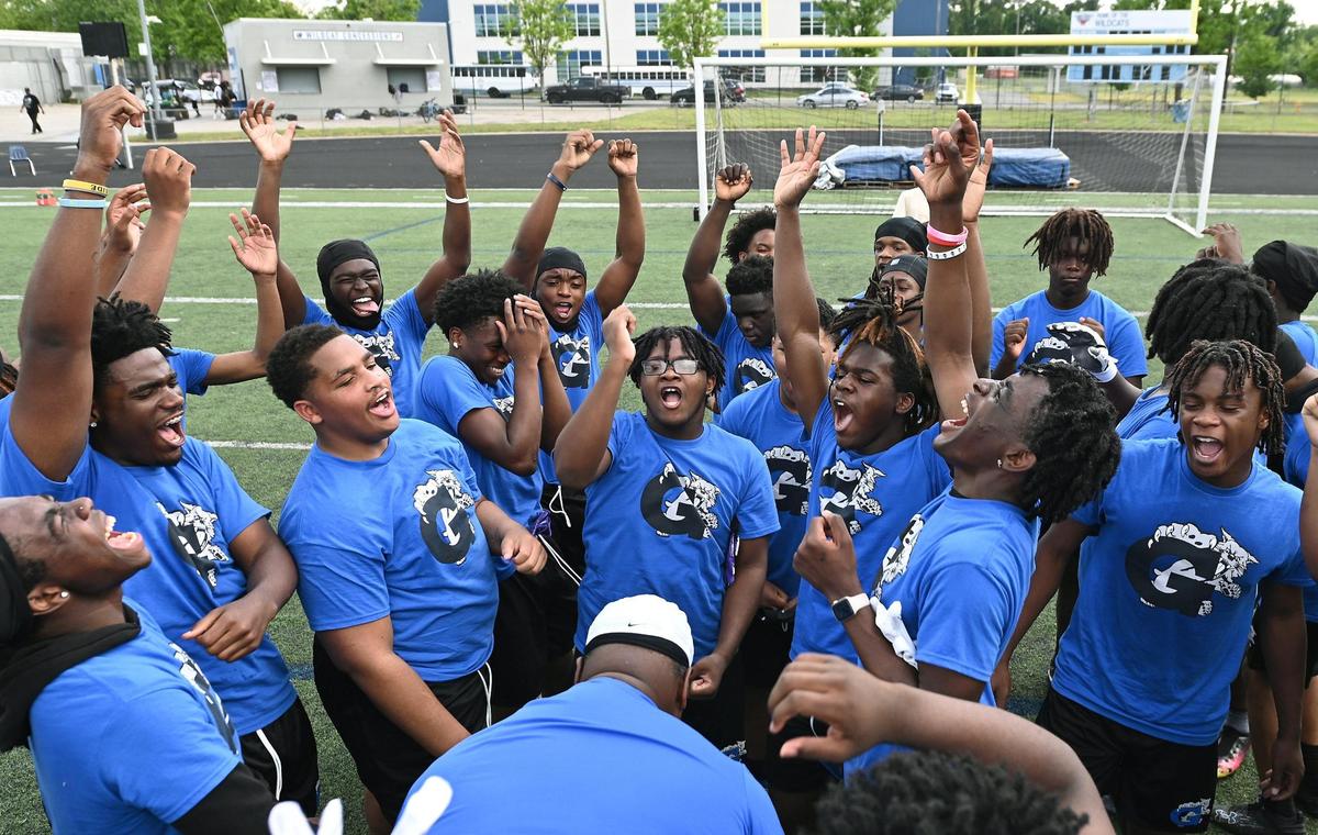 Members of the Garinger High School football team gather at the close of a workout on Tuesday, April 29, 2025.