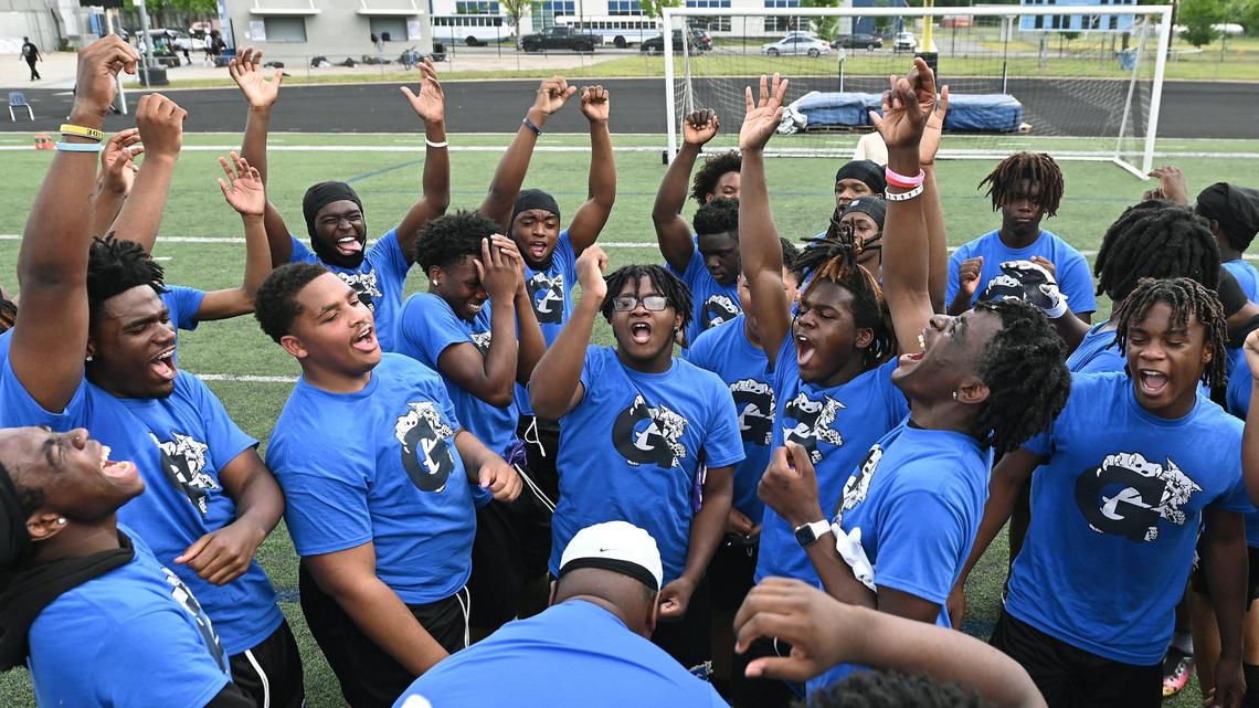 Members of the Garinger High School football team gather at the close of a workout on Tuesday, April 29, 2025.