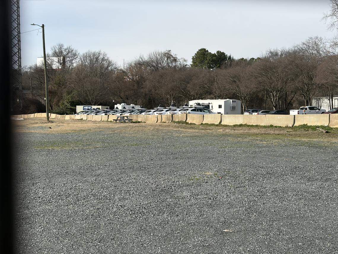 A dozen Waymo vehicle were sitting in this gravel lot in uptown Charlotte Tuesday, Feb. 24, 2026.